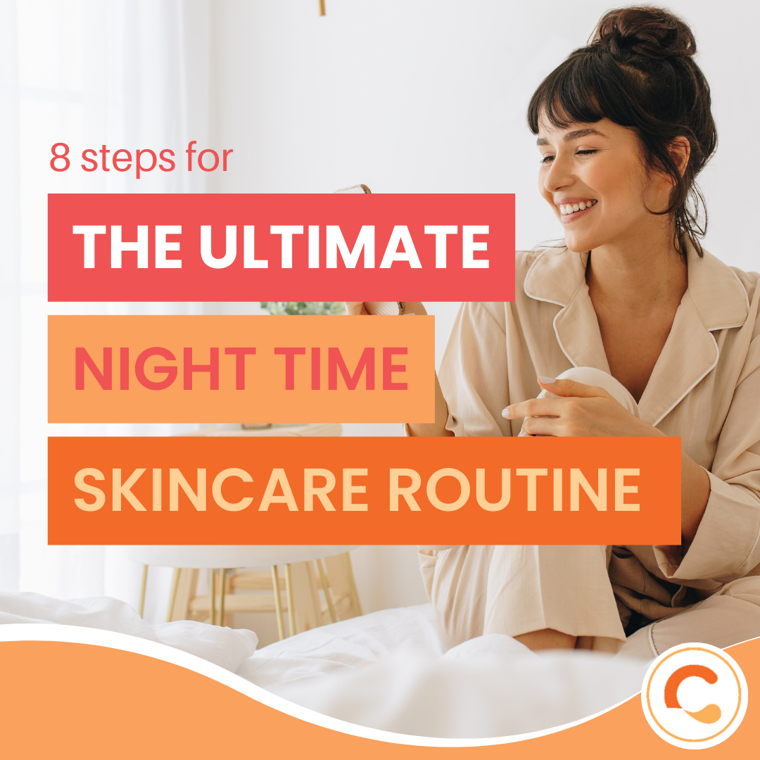 Woman in pajamas sitting on her bed applying cream to her hands as part of a nighttime skincare routine